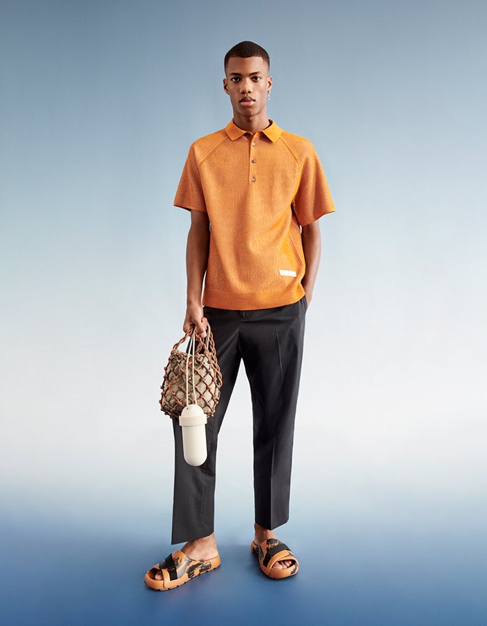 man wearing new parley clothes orange shirt black trousers