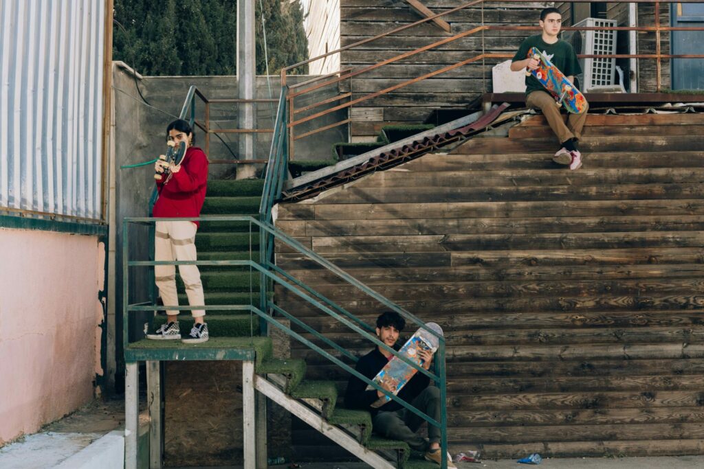 skateboarders standing defiant on staircase