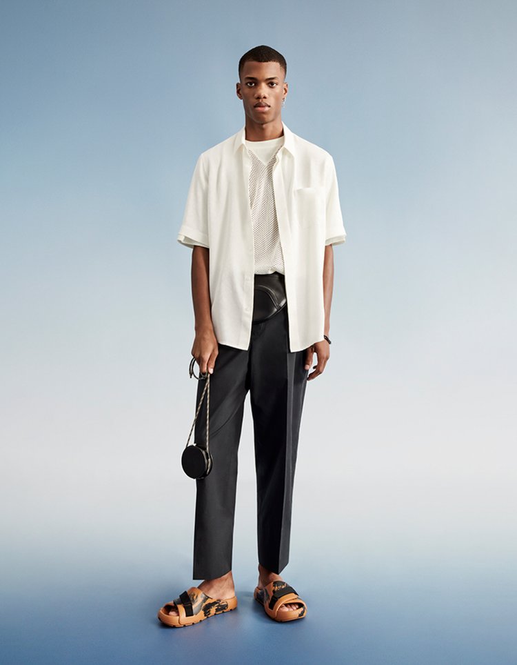 man wearing new parley clothes white shirt black trousers