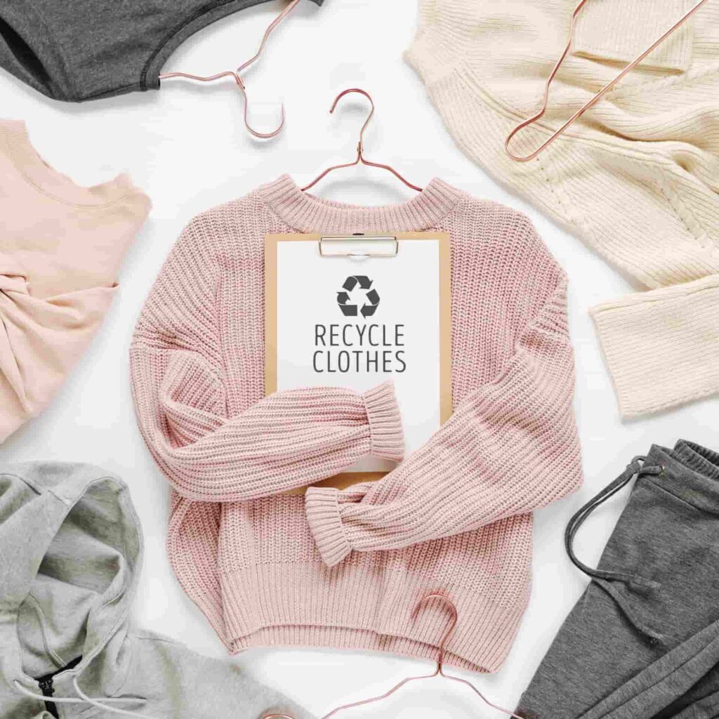Pink jumper with a recycling sign in the middle