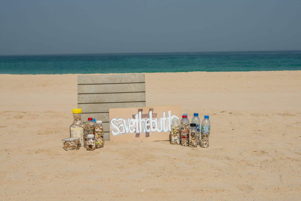 Plastic bottles filled with cigarette butts on the beach