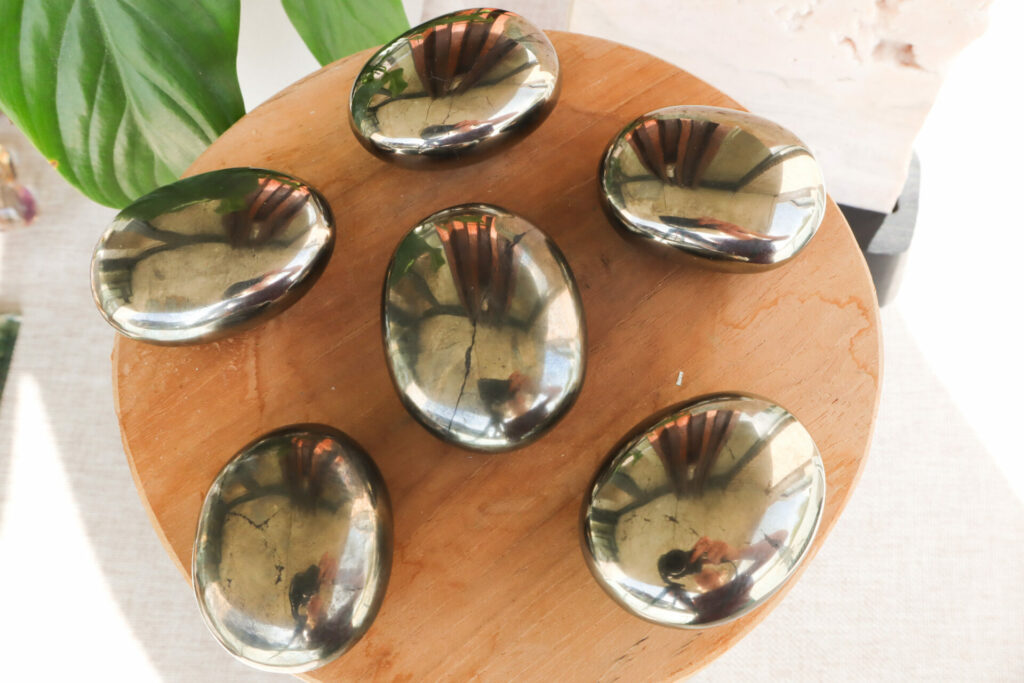 6 smooth circles of pyrite crystals on wooden surface