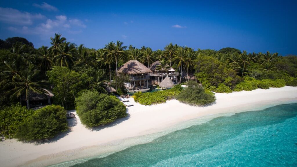 white beach and pristine blue sea at soneva fushi