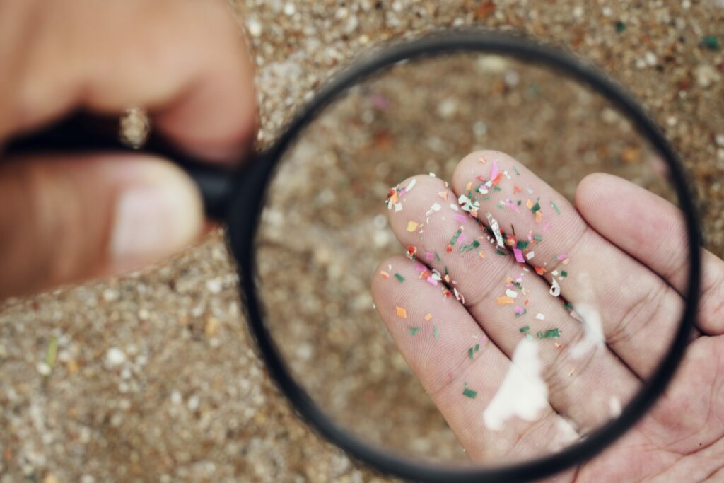 Microplastics under a magnifying glass which can come from microbeads
