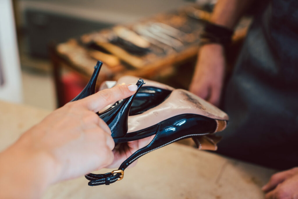 Lady fixing her high heels at cobblers