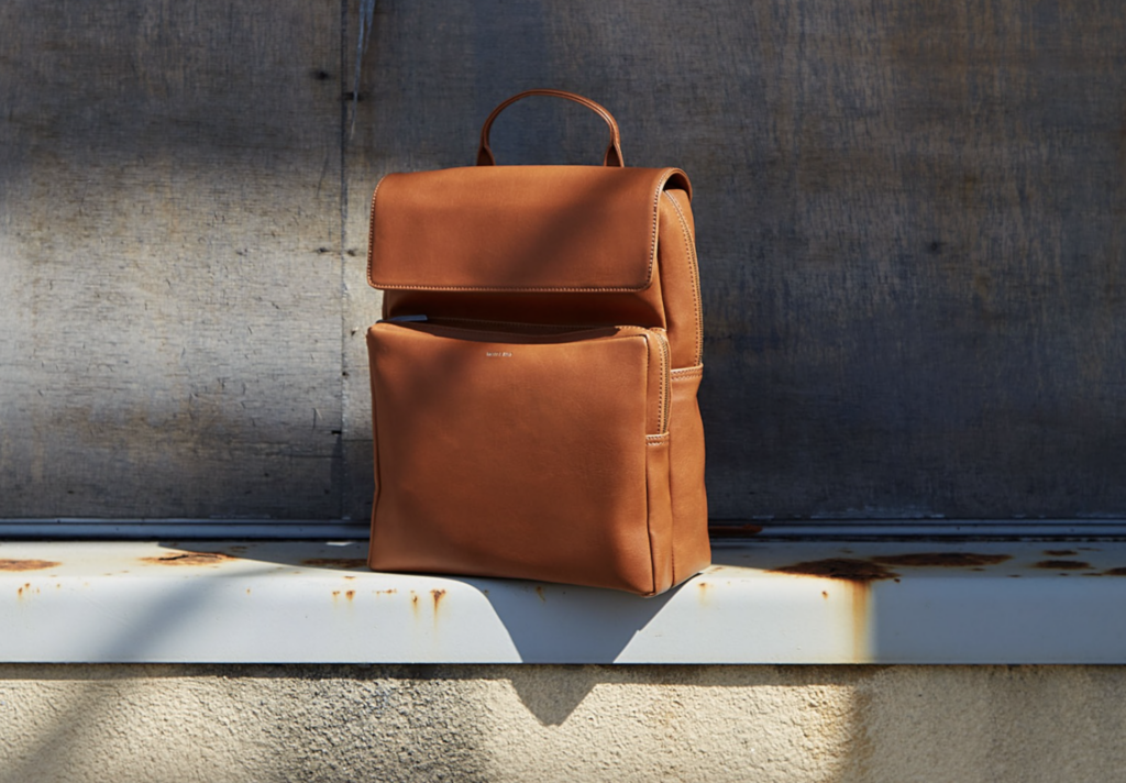Tan rucsack on an industrial ledge in the sunshine