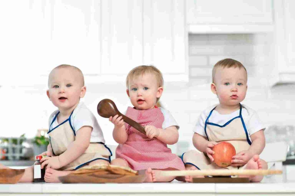 Triplets cooking. Bulk buying and meal planning means less food and packaging waste even though there are more mouths to feed