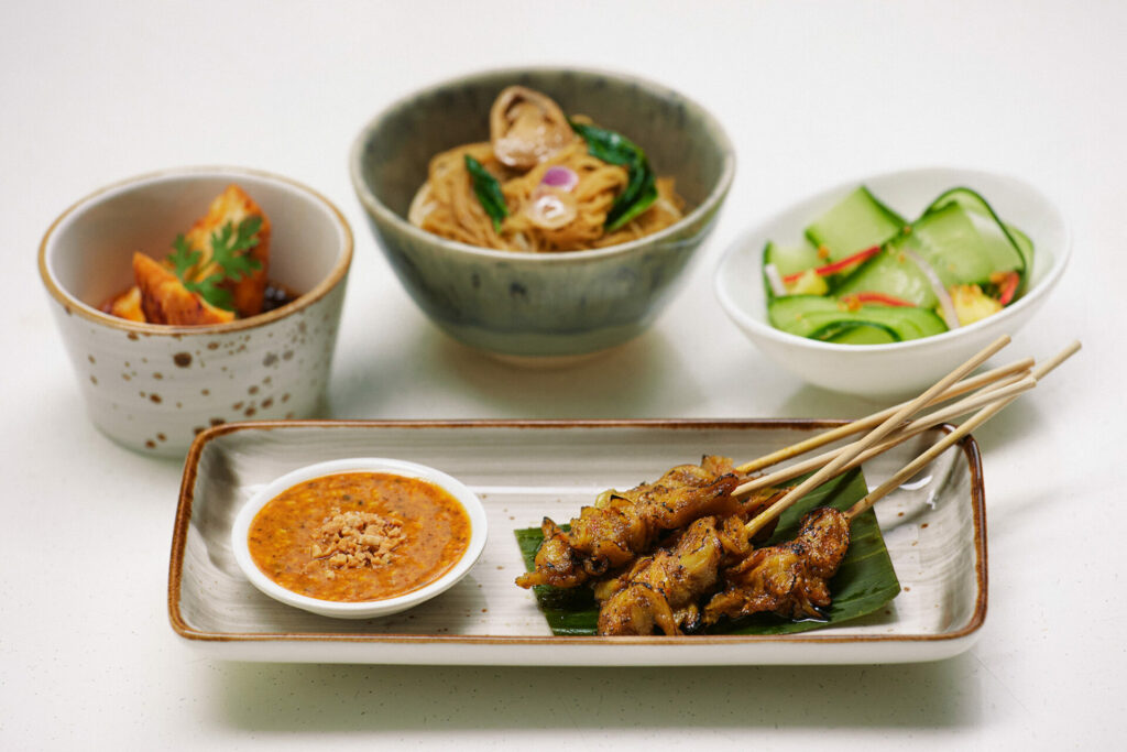 chicken skwers served with asian side dishes