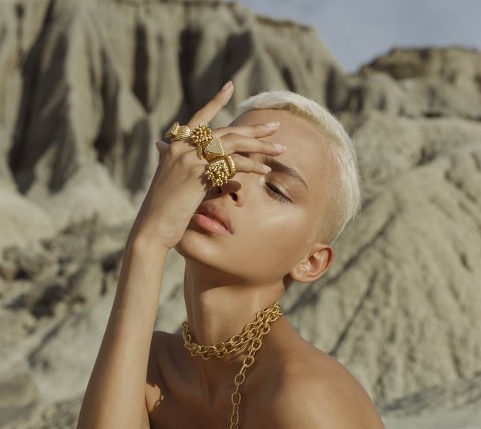 woman in desert wearing chunky gold rings 