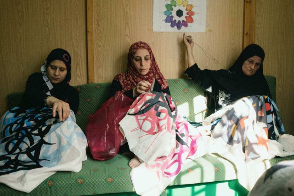refugees sat embroidering for the 81 designs project