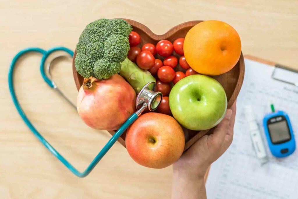 heart shape made my doctors equipment and bowl of fruits