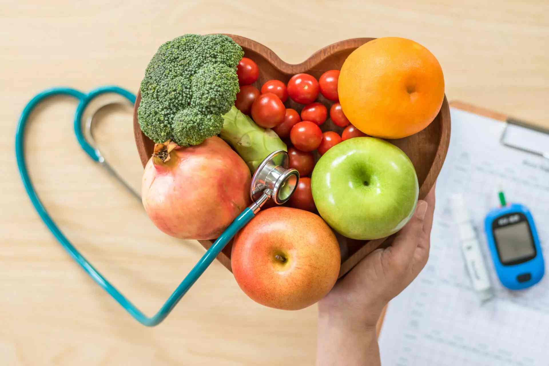 heart shape made my doctors equipment and bowl of fruits