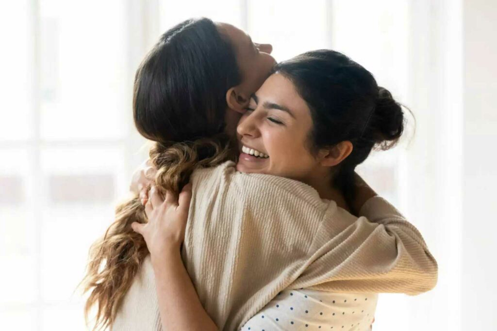 two ladies hugging and laughing