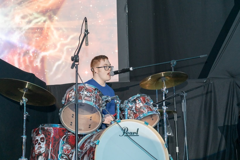 Performer playing drums at FAME show 