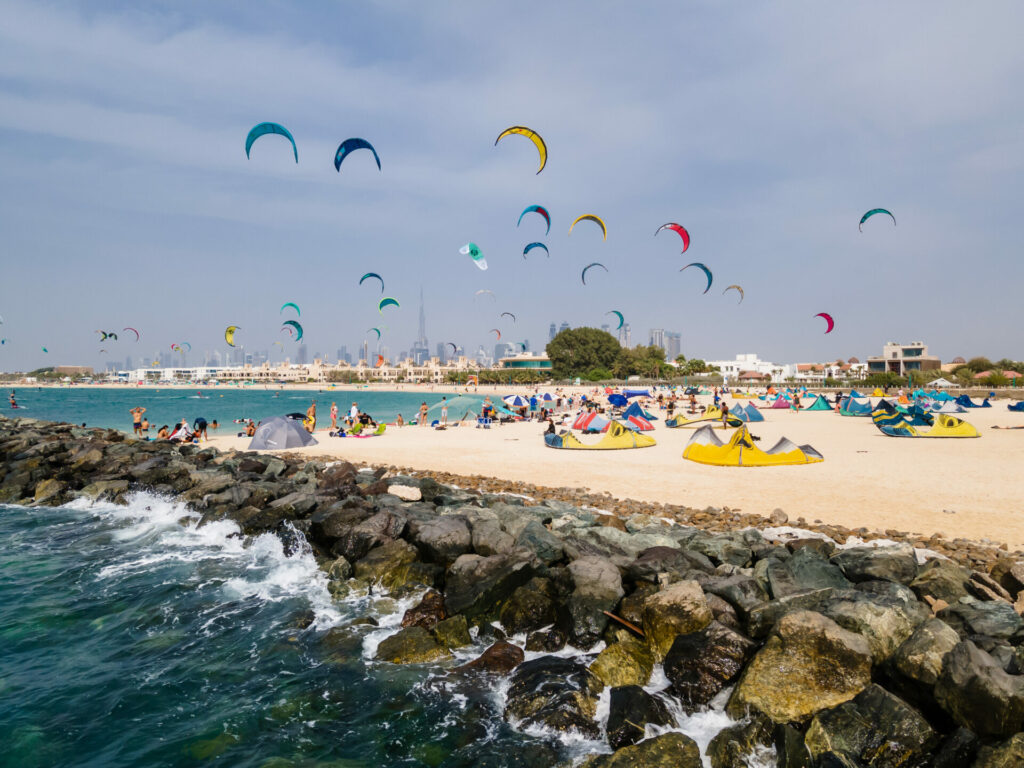 UAE beach with the sky full of kite surfers