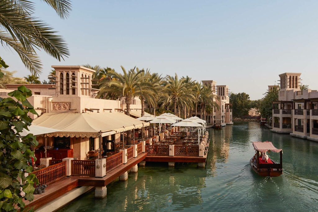 Boat on canal passing restaurant 