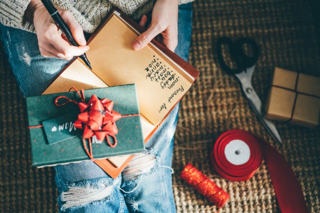 Planning helps eliminate Christmas stress: woman making present list 