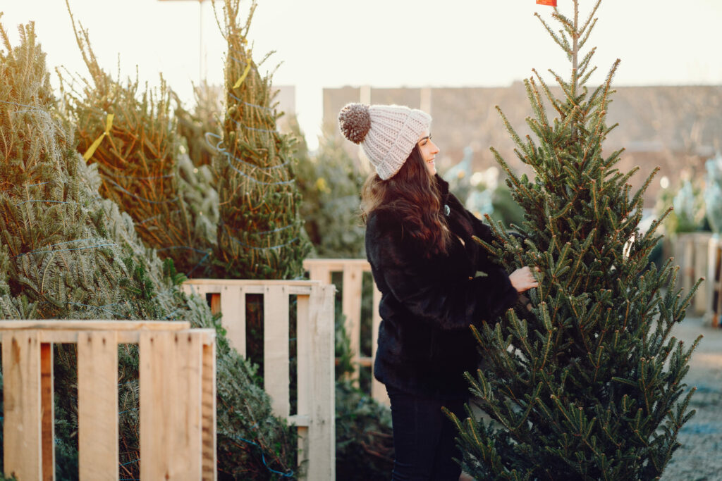 woman looking to buy Christmas tree  