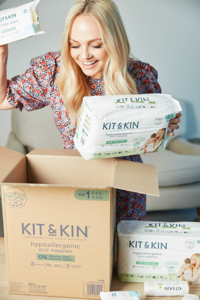 Emma Bunton looking at Kit & Kin eco nappies in box 