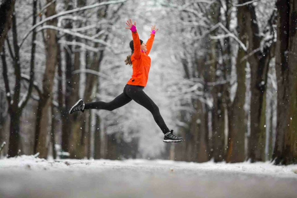 woman jumping in frost brighter january
