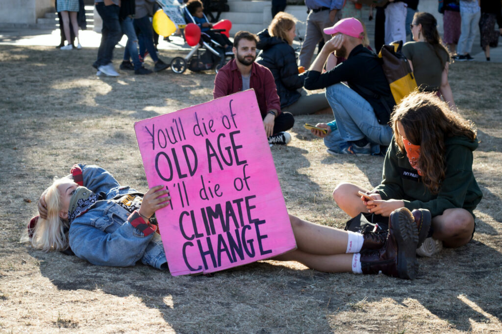 young protestors holding up sign saying: You'll die of old age, I'll die of climate change' about the climate crisis 