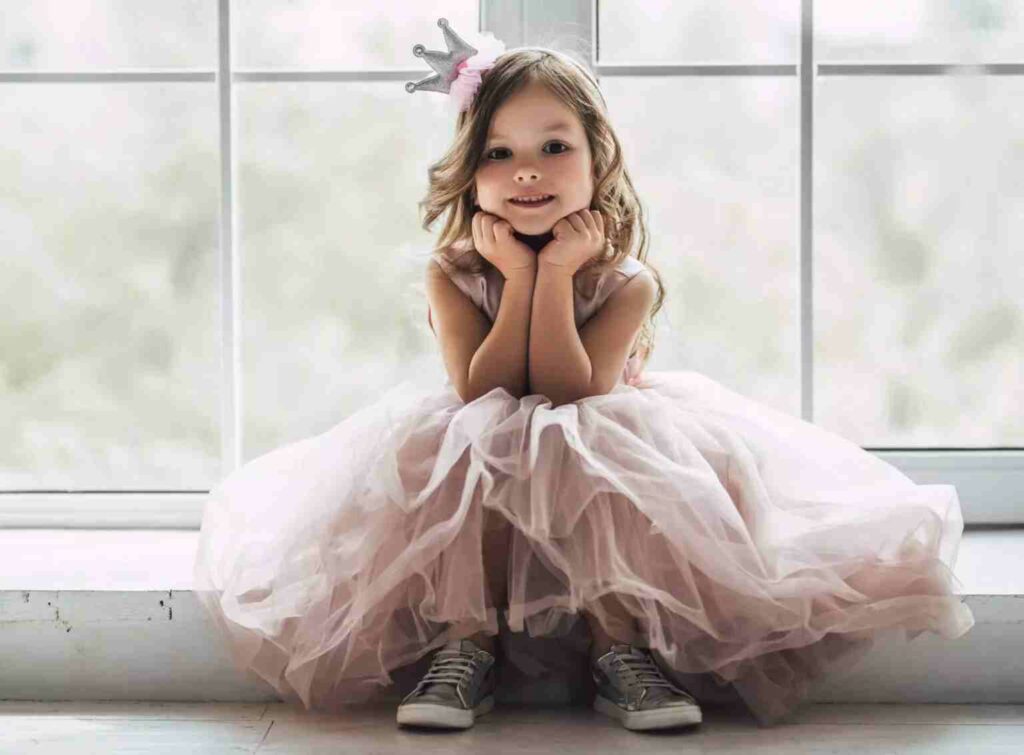 little girl in princess dress and plastic crown