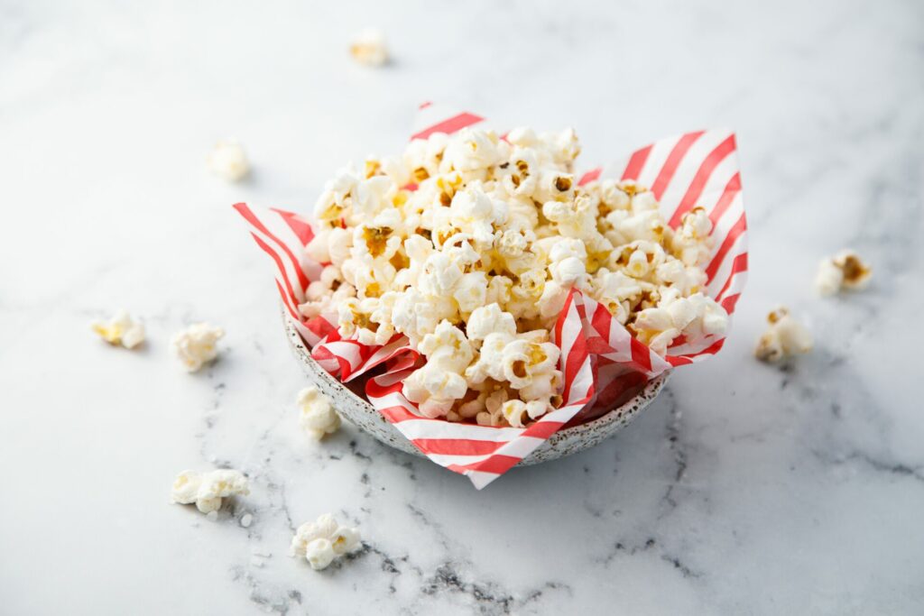 bowl of popcorn on red and white paper 