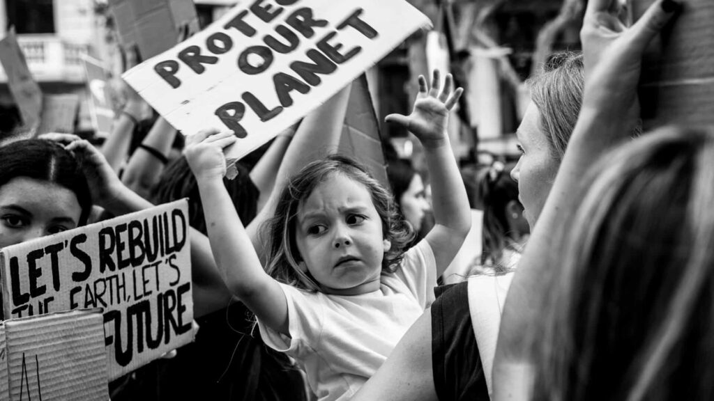 small child protesting about climate crisis