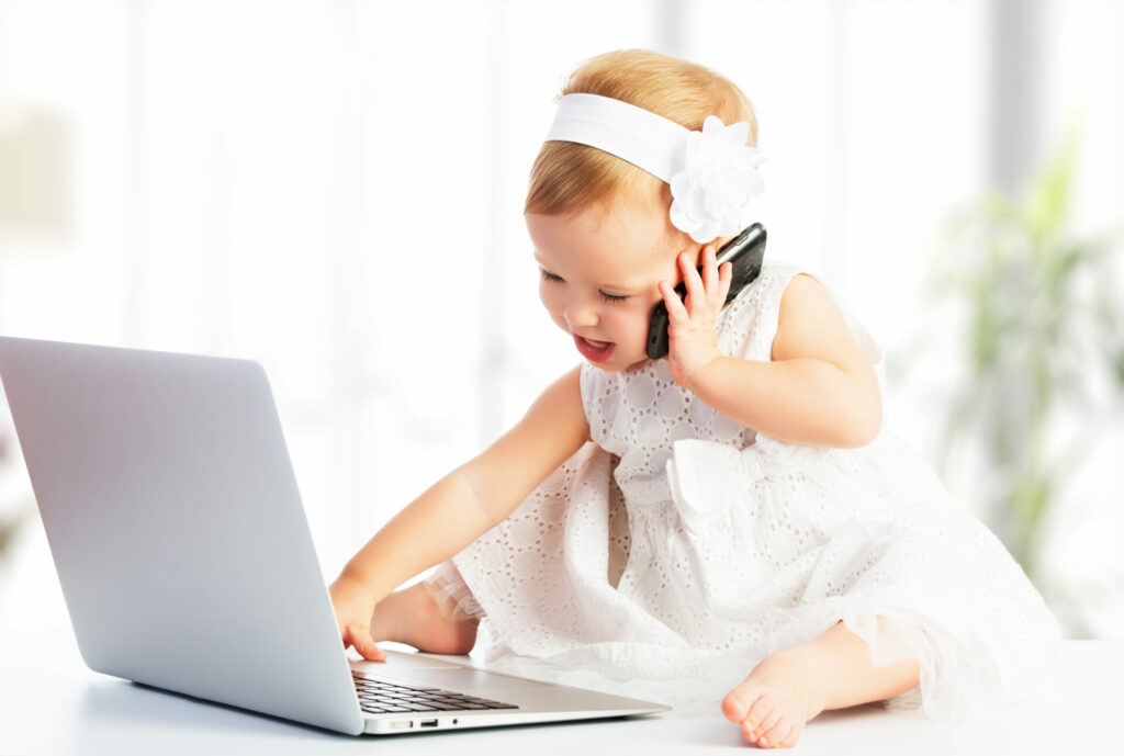 baby girl online on mobile phone and computer 