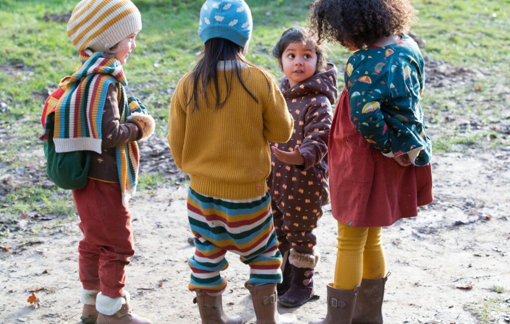 a bunch of children in rainbow kids' clothing 
