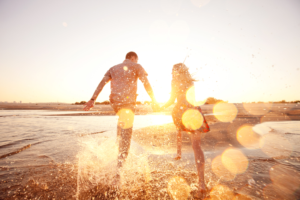 couple in love running down beach 