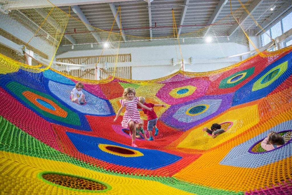 oli oli is one of the best Dubai play spaces seen here with kids jumping on a multi coloured trampoline 