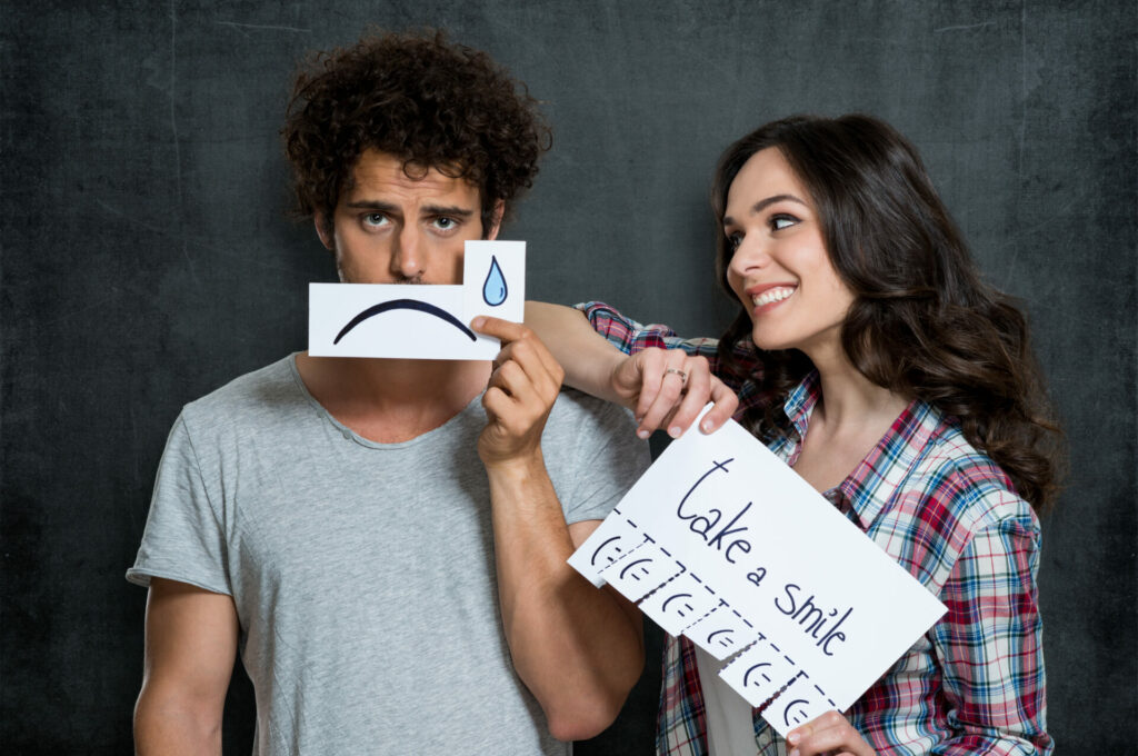 happy optimist woman tries to cheer up a pessimist 