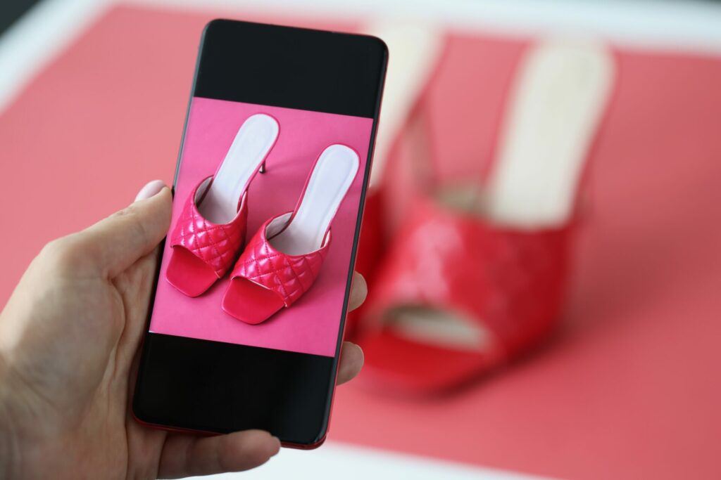 woman photographing used shoes 