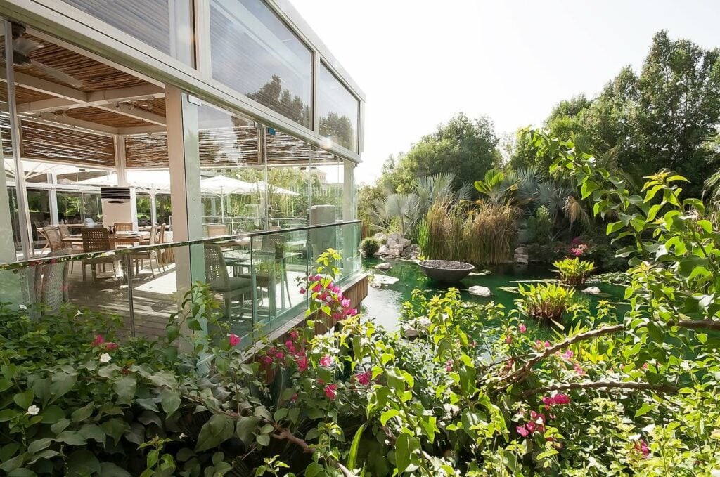 restaurant overlooking greenery and water 