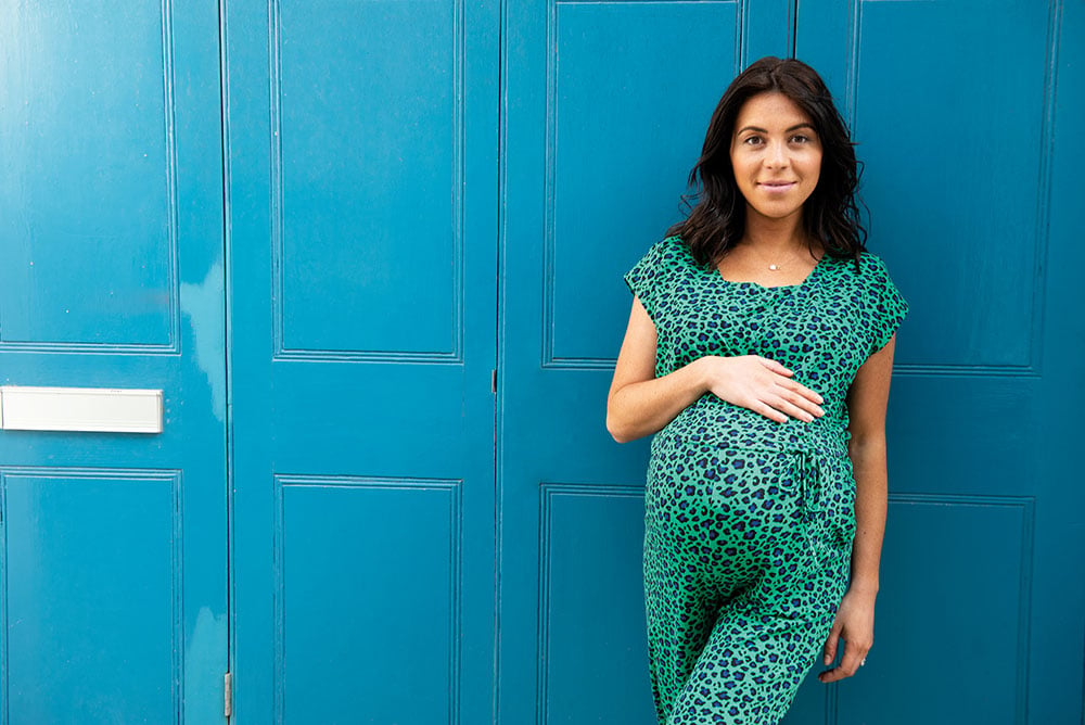 woman wearing green and black maternity dress 