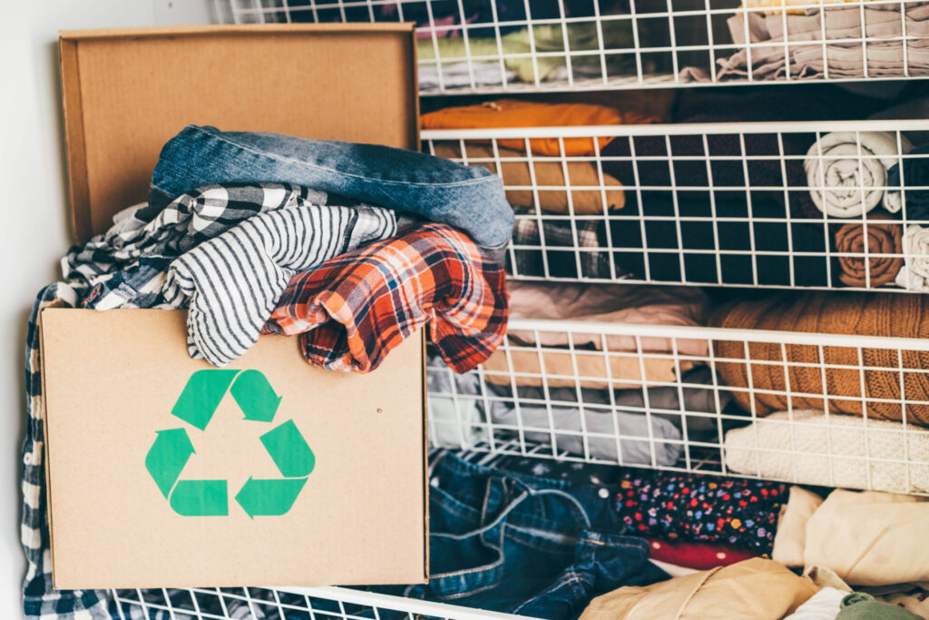 Recycle clothes concept. Recycling box full of clothes for Global Recycling Day