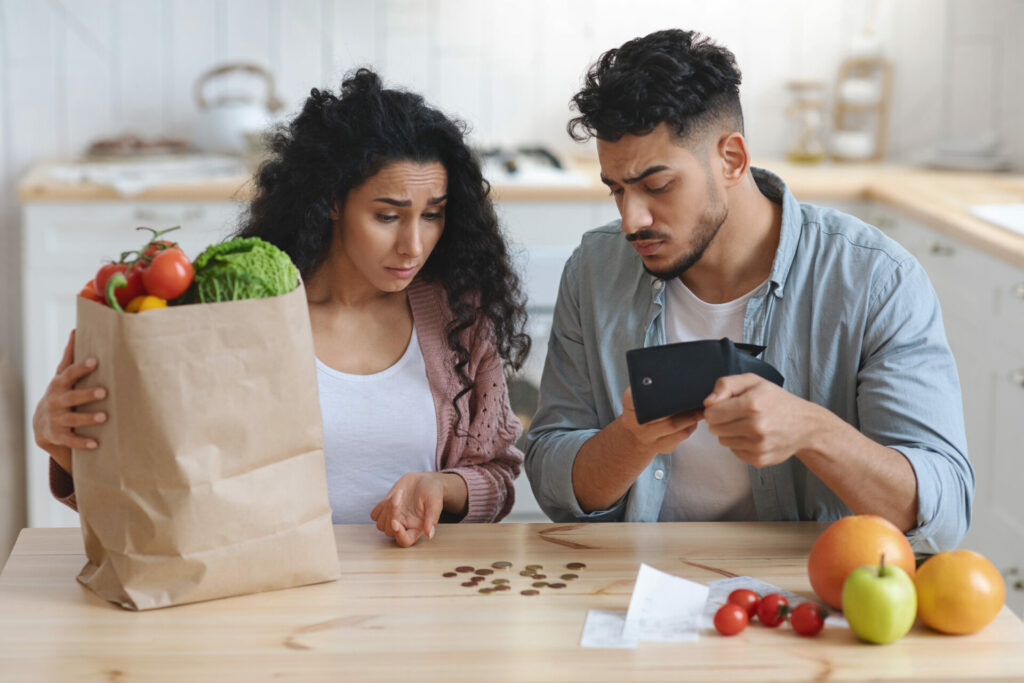 woman and man with shopping bags and money on table 