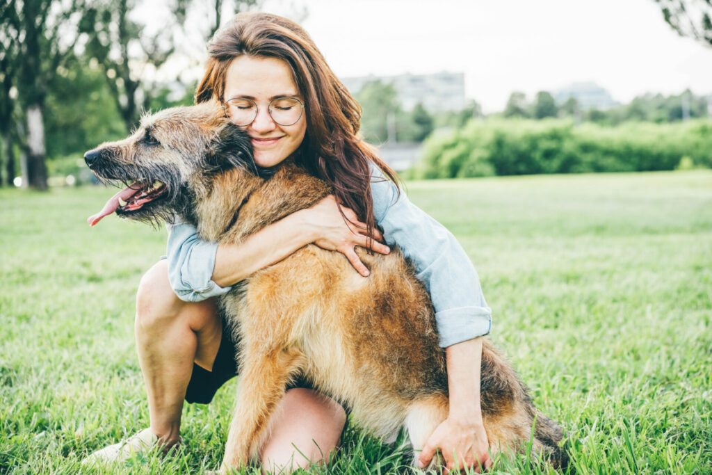 woman smiling holding dog 