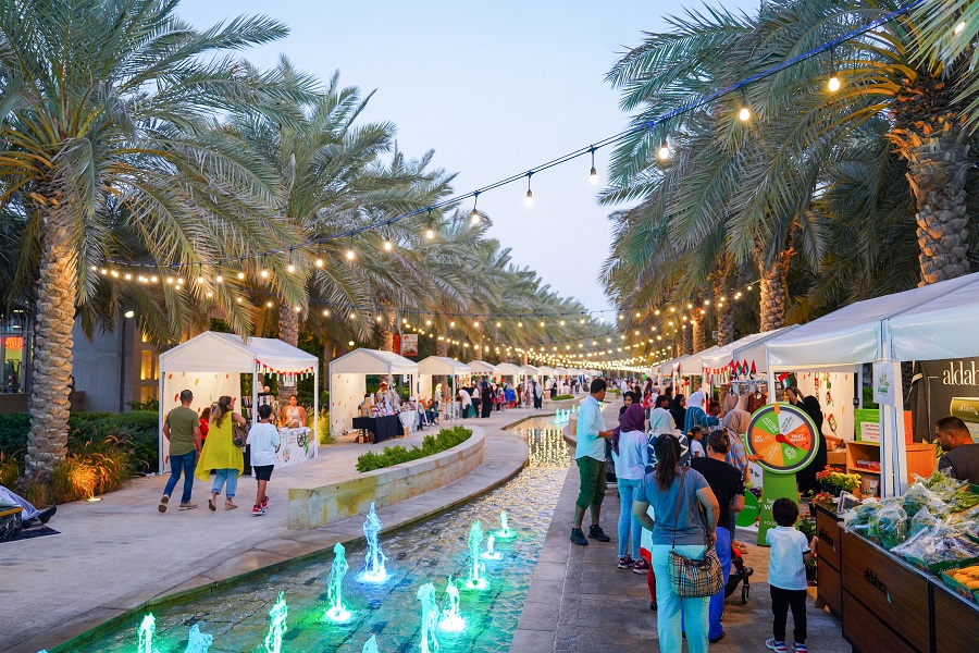 people shopping at an outdoor market 