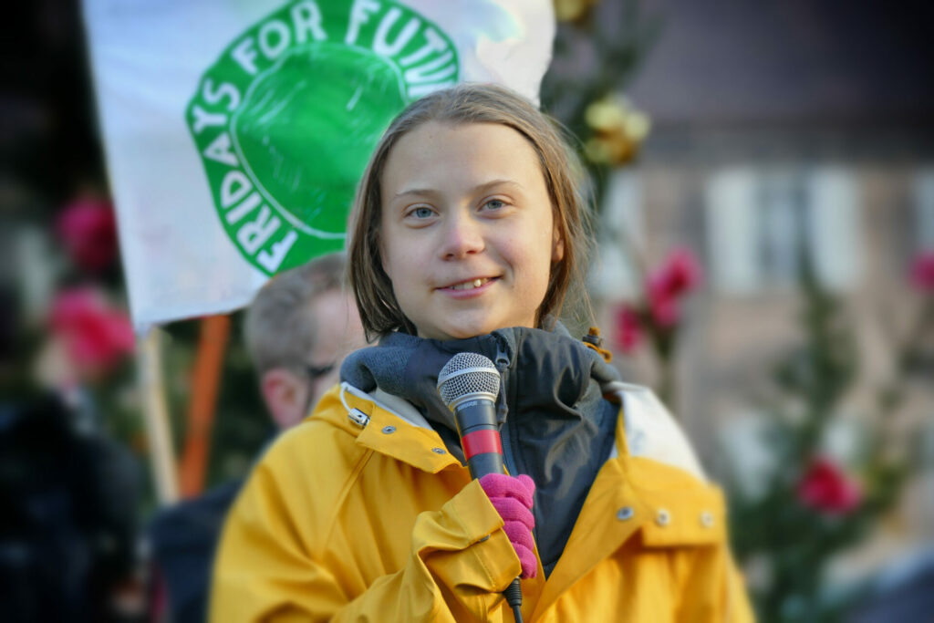 Greta Thunberg smiling to camera 