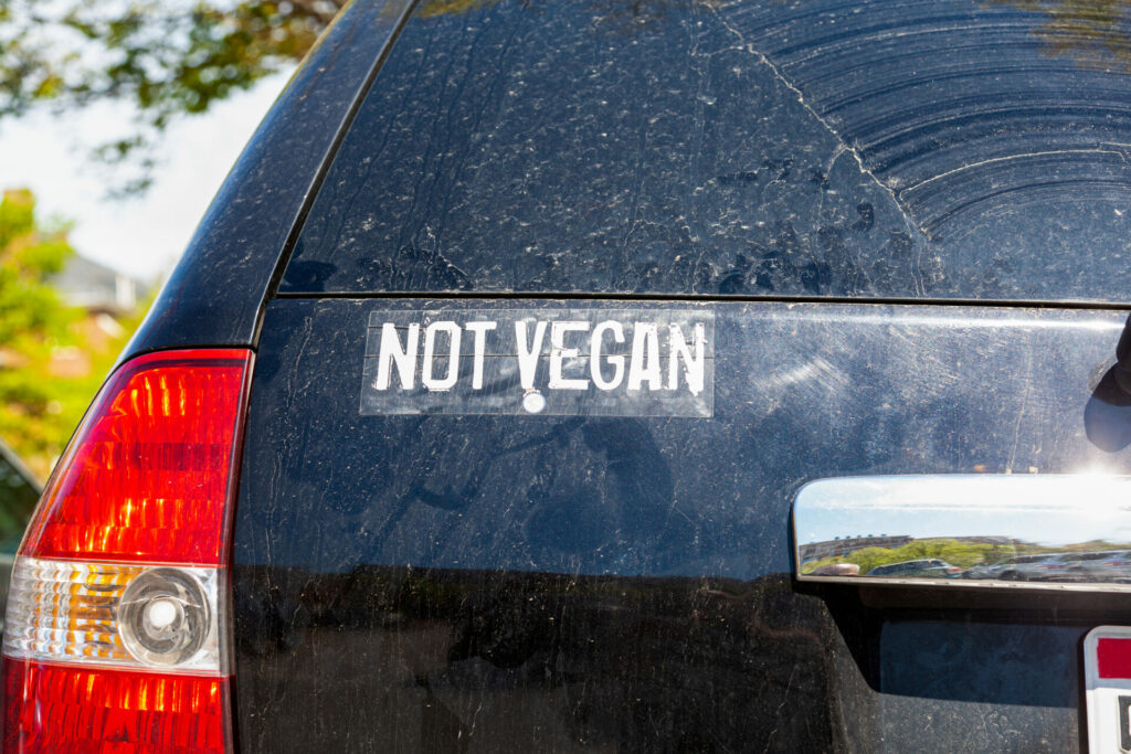 a not vegan sticker on a car indicative of a carnivore 