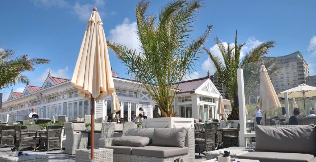 seating area with trees next to the beach