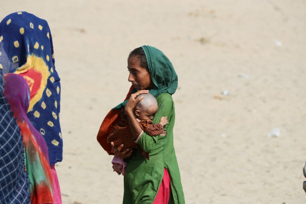 mother carries newborn baby in Pakistan 