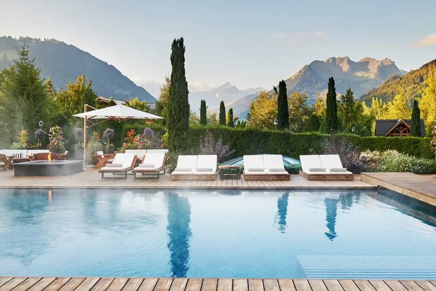 swimming pool with steam rising and mountains as backdrop