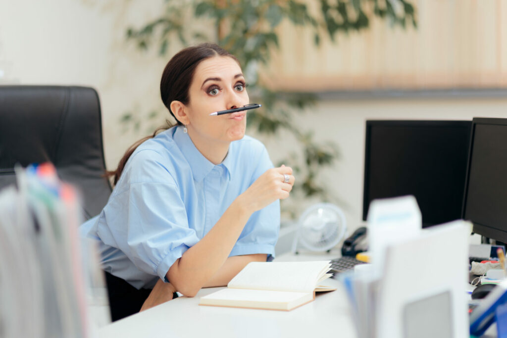 woman procrastinating at work because she has tomorrow syndrome