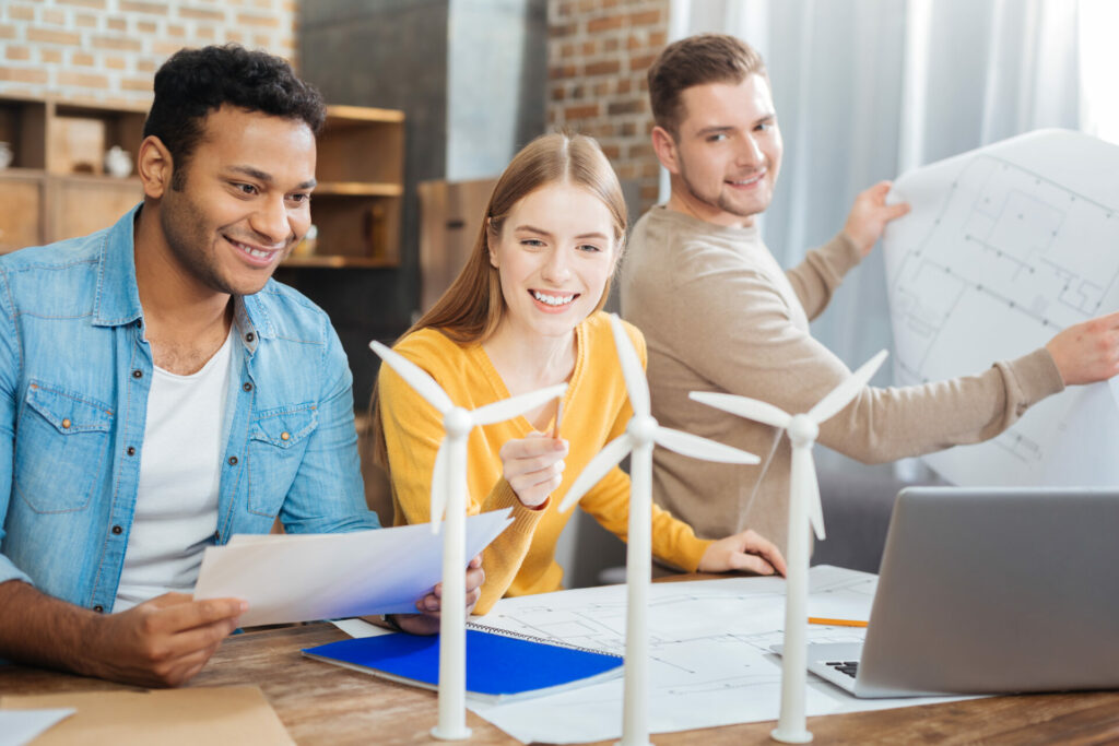 Three Gen Z'rs working on wind power model  