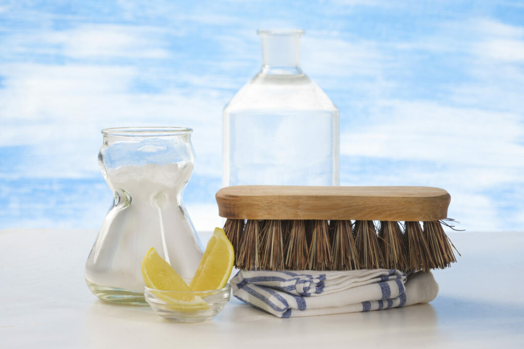 natural cleaning products with a clear blue sky behind 