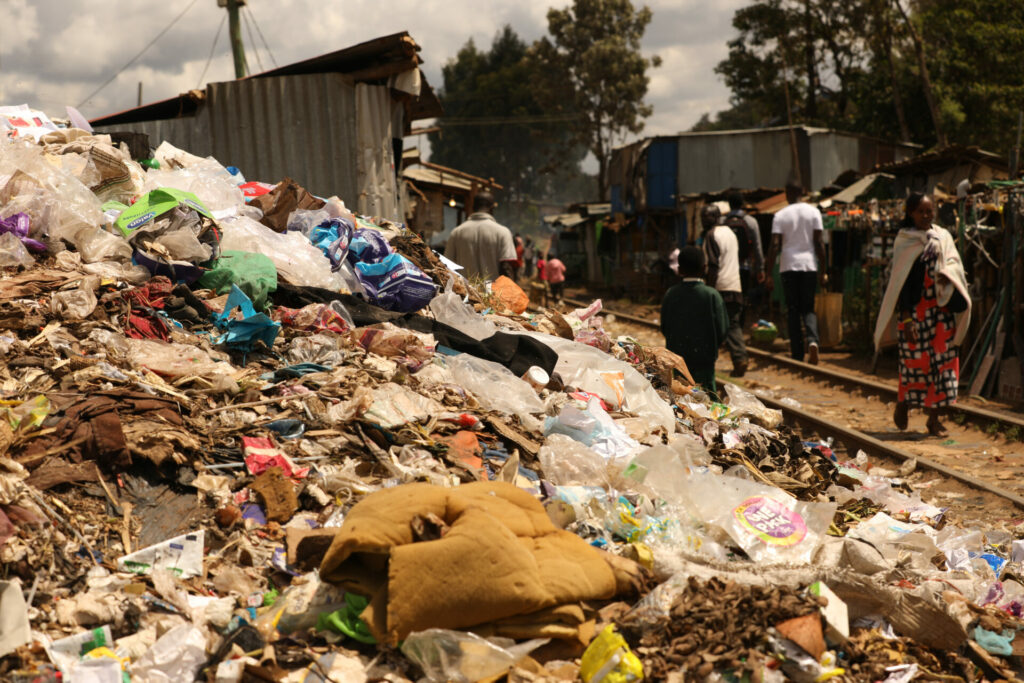 rubbish by side of road in Kenya where Europe sends fast fashion clothes filled with plastic 