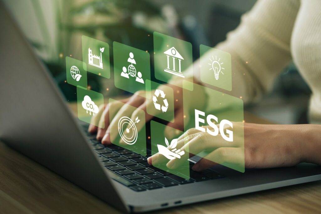 Woman on laptop showing green ESG investments 